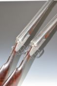 A pair of Cogswell & Harrison Ltd 12 bore side by side ejector shotguns, each with scrolling