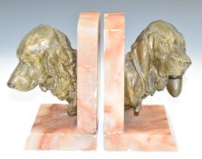 After Prosper Lecourtier (French 1851-1924) Art Deco pair of pink onyx and bronzed spelter bookends,