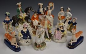 A collection of Staffordshire figures including a pair of greyhound pen stands, tallest