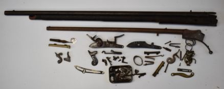 A collection of gun parts and accessories including the barrel and action for a Martini under-