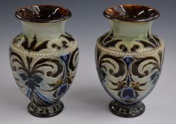 Pair of Royal Doulton pedestal vases decorated with flowers, foliage and beadwork, monogrammed for