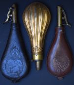 Three powder/ shot flasks, one copper and brass with reeded decoration, another with embossed