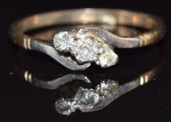 A 9ct gold ring set with three diamonds in a platinum twist setting, size R, 2.3g