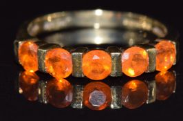 A 9ct gold ring set with fire opals, size L, 2.g