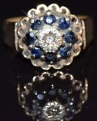A 9ct gold ring set with a diamond surrounded by sapphires, size O, 4.7g