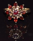 A 9ct gold ring set with garnets in a cluster, size J, 2.7g