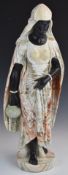 A finely carved variegated marble figurine of North African water carrier in black and veined