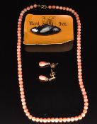 A single strand of coral beads, pair of 9ct gold earrings set with coral and a Whitby jet brooch