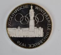 Eight Austria Olympic Games 1976 coins together with a Poland example and a Tonga 5 pa'anga,
