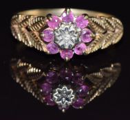 A 9ct gold ring set with a diamond and rubies, size N, 2.6g