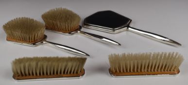 Hallmarked silver dressing table set, comprising hand mirror and four brushes, length of mirror