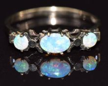 A 9ct gold ring set with opals, size P, 1.4g
