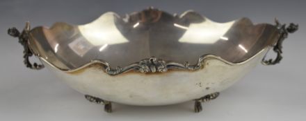 Continental white metal oval bowl with winged cherub handles, raised on four feet, marked 800 to