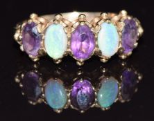 A 9ct gold ring set with opals and amethyst, size P, 3.2g