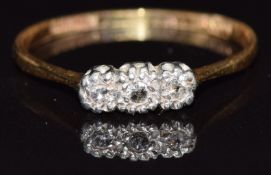An 18ct gold ring set with three diamonds, size O, 1.7g