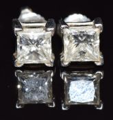 A pair of platinum earrings set with a princess cut diamond of approximately 1ct to each, 3.7g