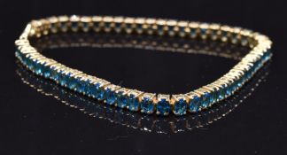 A 9ct gold bracelet set with 56 oval cut apatite, 12.5g