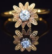 An 18ct gold ring set with a diamond of approximately 0.2ct in a flower setting, size L/M, 3.2g