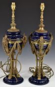 Pair of porcelain and bronze / brass Royalcore pedestal table lamps with ram mask and swag