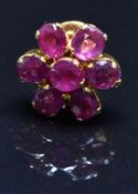 A yellow metal earring set with a cluster of rubies, 1.3g