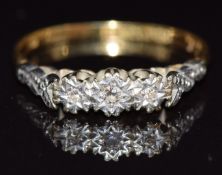An 18ct gold ring set with three diamonds in a platinum setting, size N, 2.4g