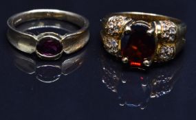 Two 9ct gold ring set with garnets, size N, 8.8g