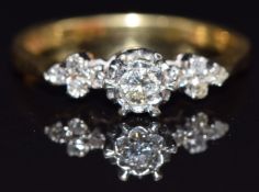 An 18ct gold ring set with diamonds, the largest approximately 0.15ct, size P, 3.7g