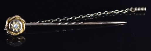 Victorian yellow metal stick pin set with a diamond in a star setting, 2g