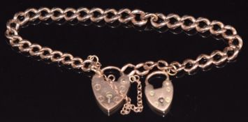 A 9ct rose gold curb link bracelet with two heart padlocks/ clasps, 16.2g