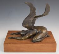 Bronze study of a prostrate winged man raised on a wooden plinth, W24 x D16 x H21cm