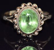 A 9ct gold ring set with an oval cut peridot, size L, 2.9g