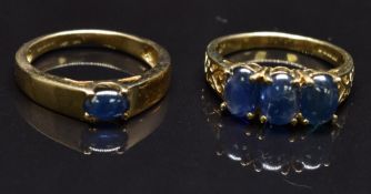 Two 9ct gold rings set with sapphire cabochons, size N, 6g