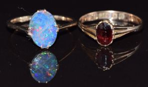 Two 9ct gold rings, one set with an opal doublet the other a garnet, size M, 2.7g