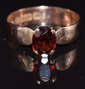A 9ct gold ring set with an oval cut garnet, size Q, 2.4g