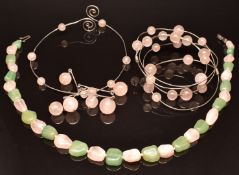 A matching silver bangle and necklace set with rose quartz beads together with a beaded rose
