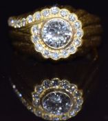 An 18ct gold ring set with a diamond of approximately 0.7ct surrounded by further diamonds, size