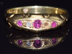 An 18ct gold ring set with rubies and a diamond, size K, 2.9g