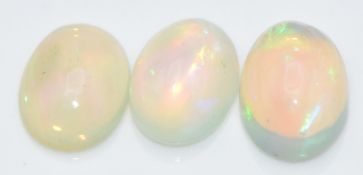 Three loose oval opal cabochons, total approximately 2.64cts