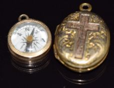 Victorian locket with cross decoration and a yellow metal compass charm