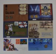 A collection of military and sporting related coin and stamp presentation packs