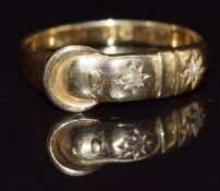 An 18ct gold buckle ring set with two diamonds, c1900, size O, 2.3g