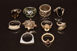 Ten silver rings set with diamonds, garnets amethyst, quartz, etc