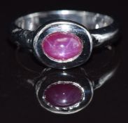 A 9ct white gold ring set with a synthetic star ruby, size M, 4.4g