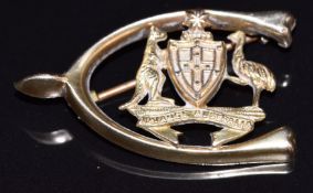 A 9ct 'Advance Australia' wishbone brooch bearing coat of arms and stamped 