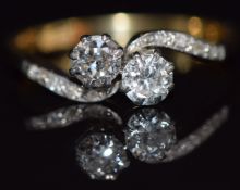 An 18ct gold ring set with two diamonds, each approximately 0.2cts in a platinum setting, with