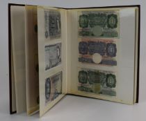 Collection of approximately seventy world banknotes in an album, to include Norman Fenwick-Warren