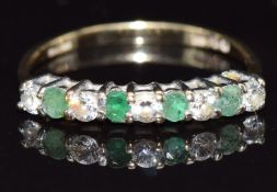 A 9ct gold half eternity ring set with cubic zirconia and emeralds, size M, 1.3g