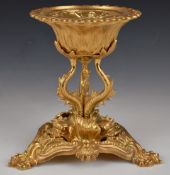 A gilt metal Royalcore centrepiece with relief moulded decoration, raised on fish shaped supports,