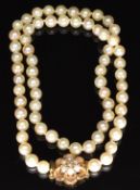 A single strand of pearls with 9ct gold clasp set with pearls in a cluster