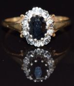 A 9ct gold ring set with an oval sapphire and diamonds, size N 2.3g